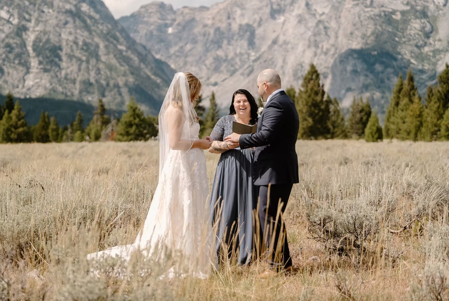 Jenn and Wilde Heart Ceremonies marrying a couple in mountain landscape