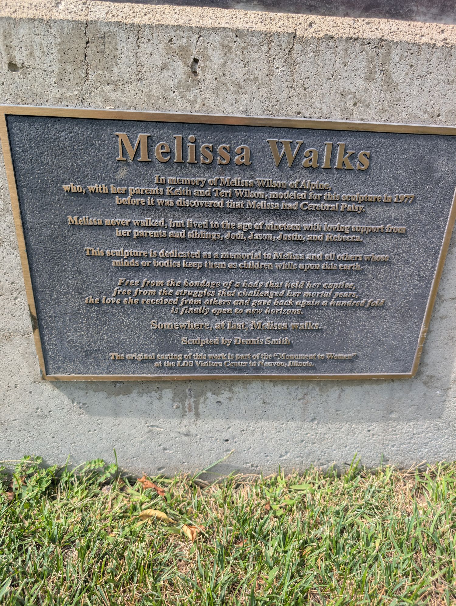 Bronze memorial plaque at the base of the Melissa Walks statue, dedicated to Melissa Wilson of Alpine and sculpted by Dennis Smith
