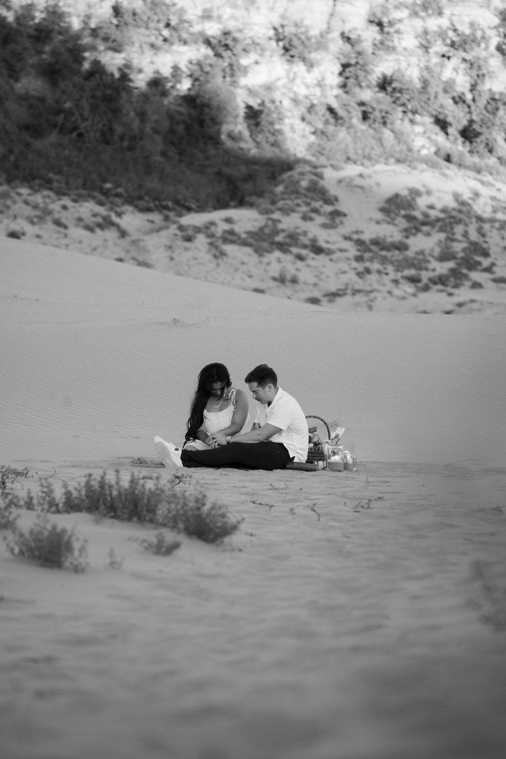 Couple standing close together at golden hour in a desert landscape, representative of Jade's proposal photography style