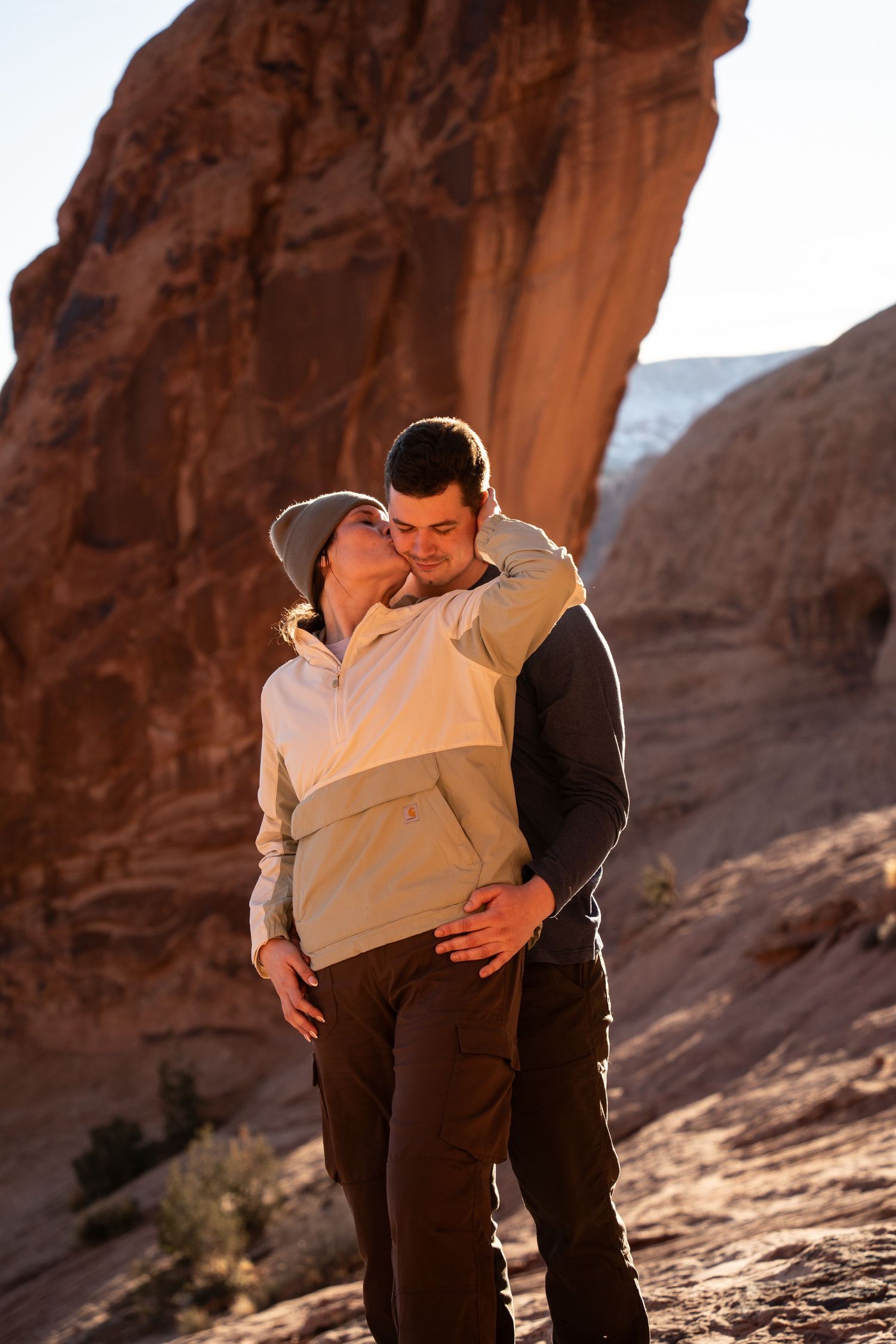 Couple sharing a romantic kiss among red rock formations