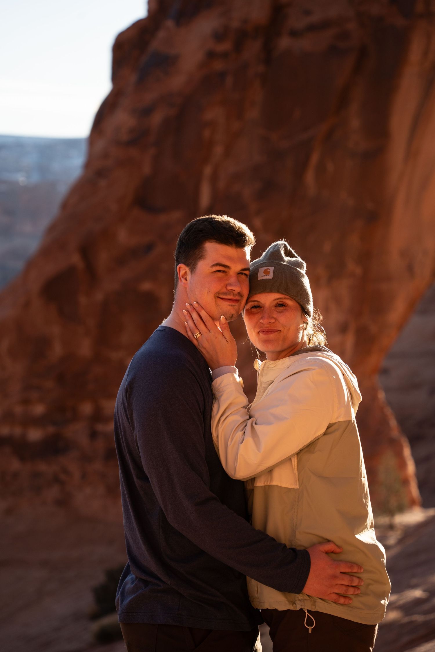 Couple embracing at golden hour in a red rock canyon