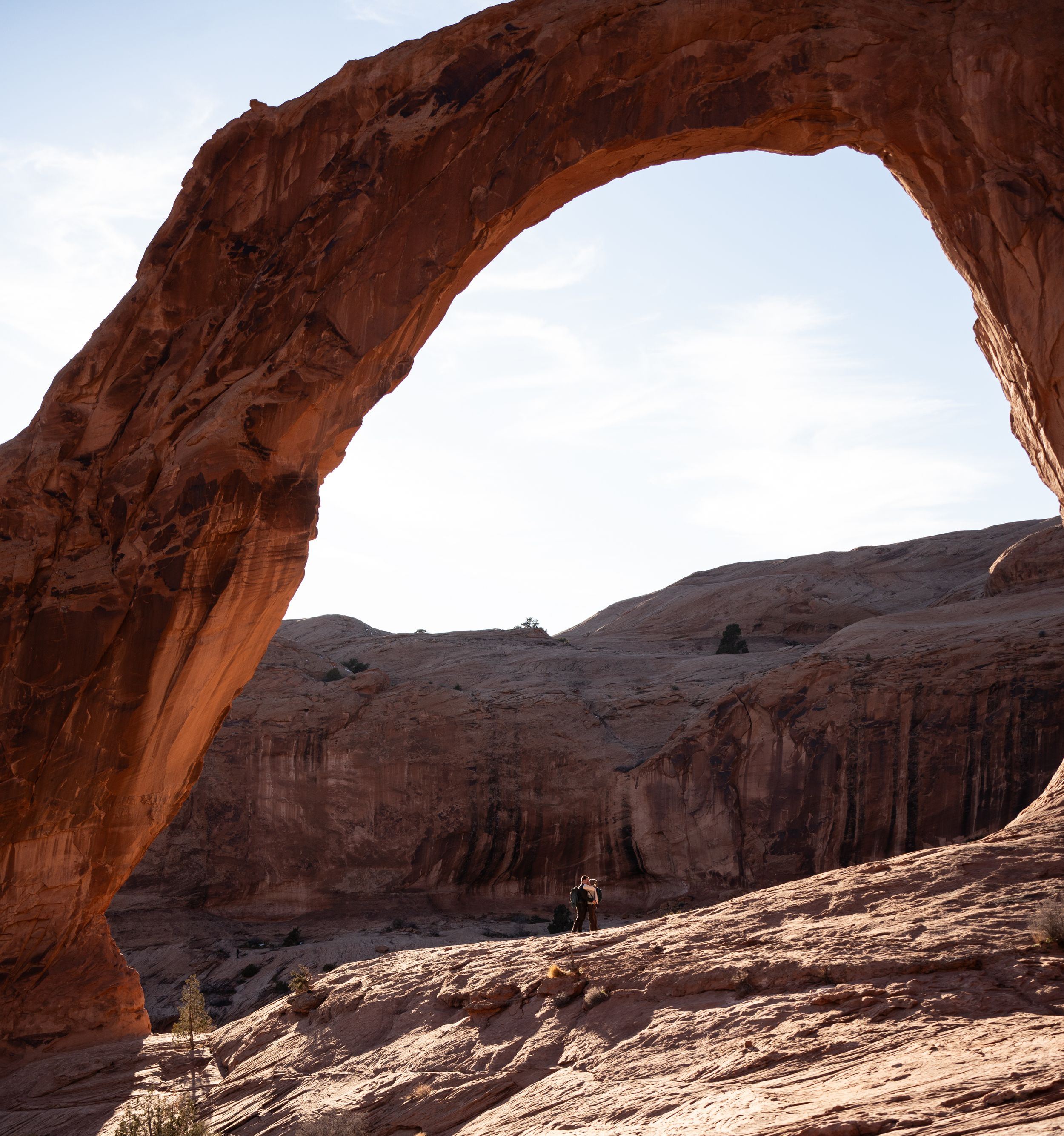Massive red sandstone arch framing the desert landscape at Corona Arch near Moab, Utah