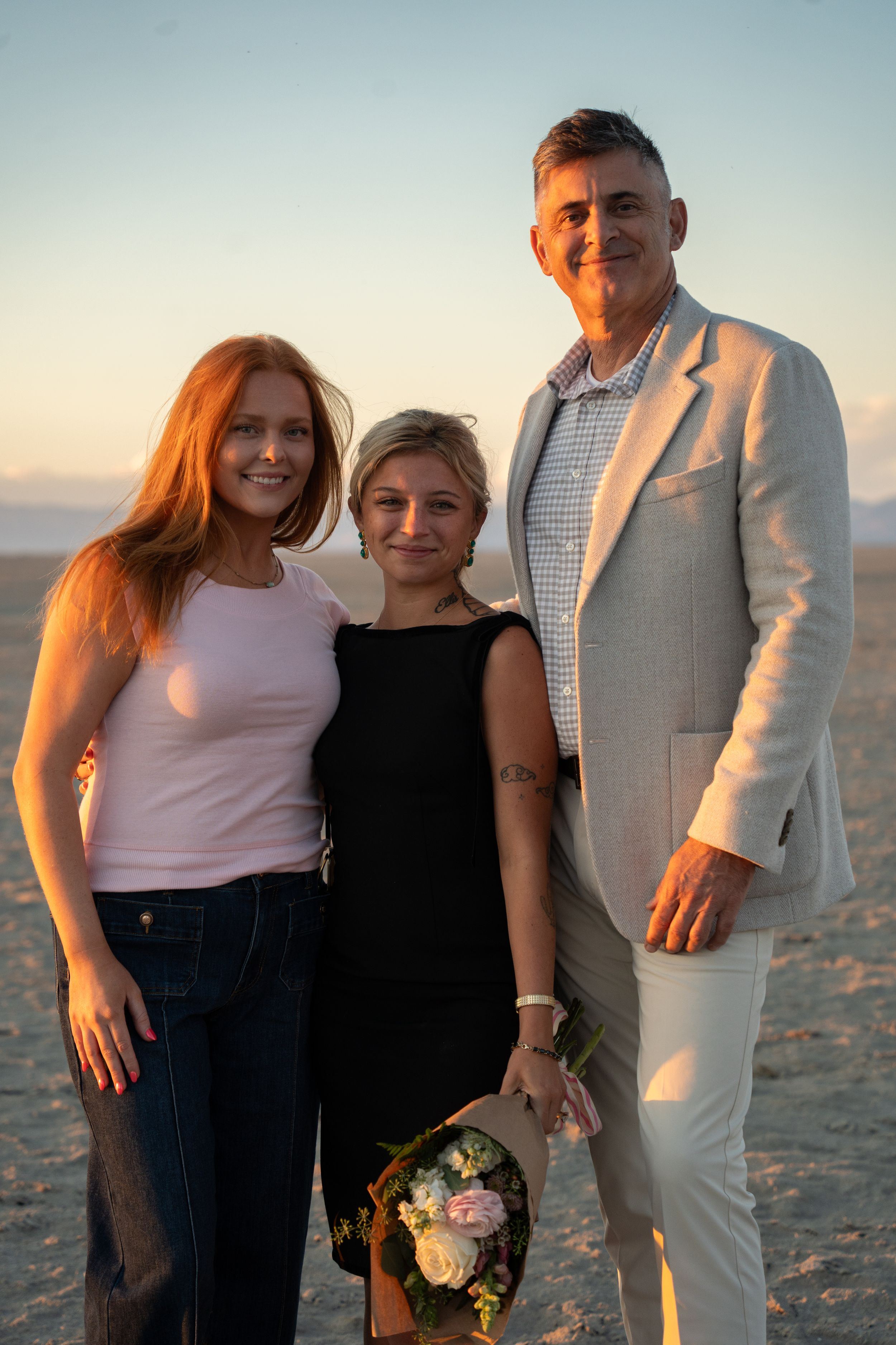 newly engaged couple with her best friend after proposal on the Utah Salt Flats