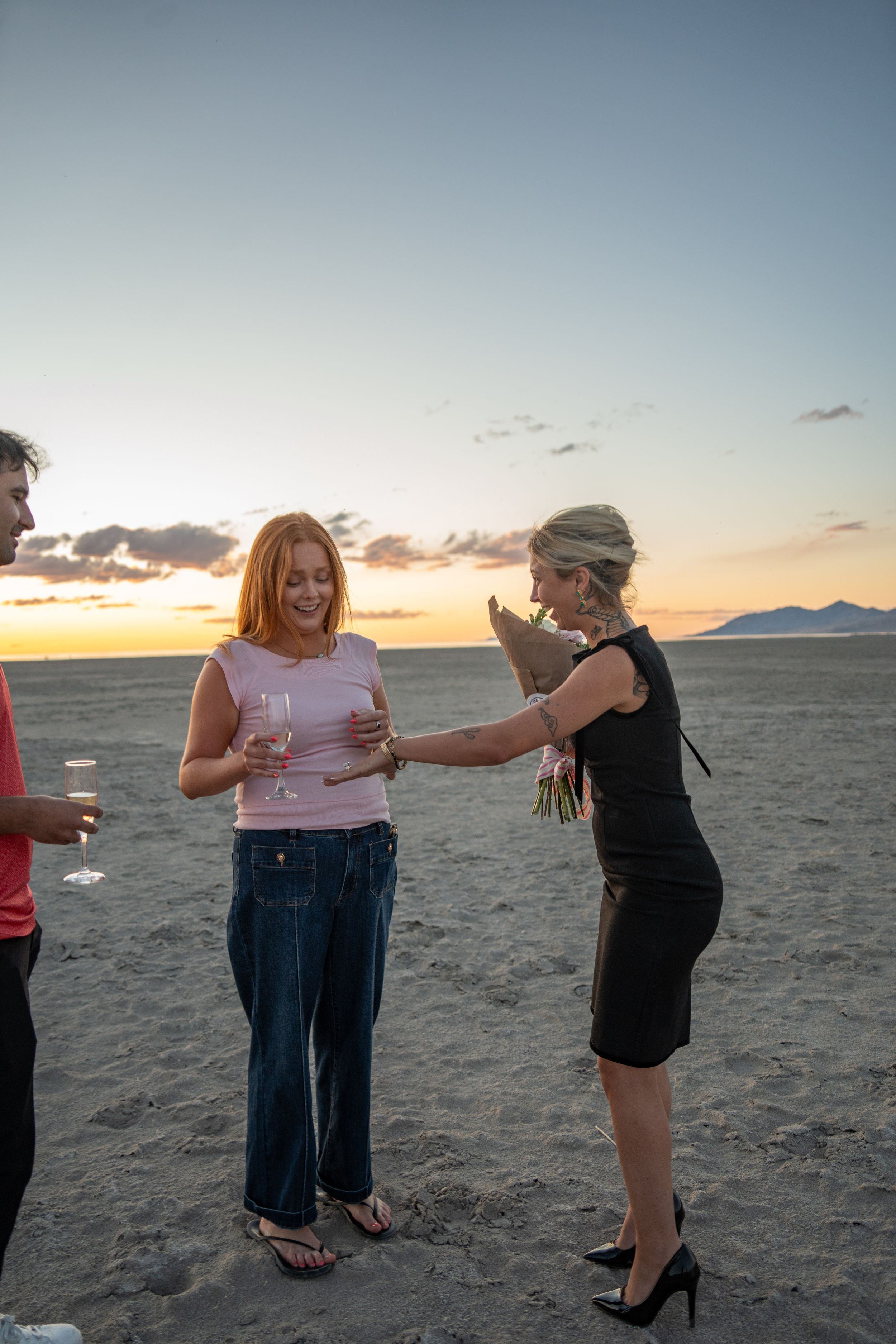 girl showing off her engagement ring to her best friend while exclaiming