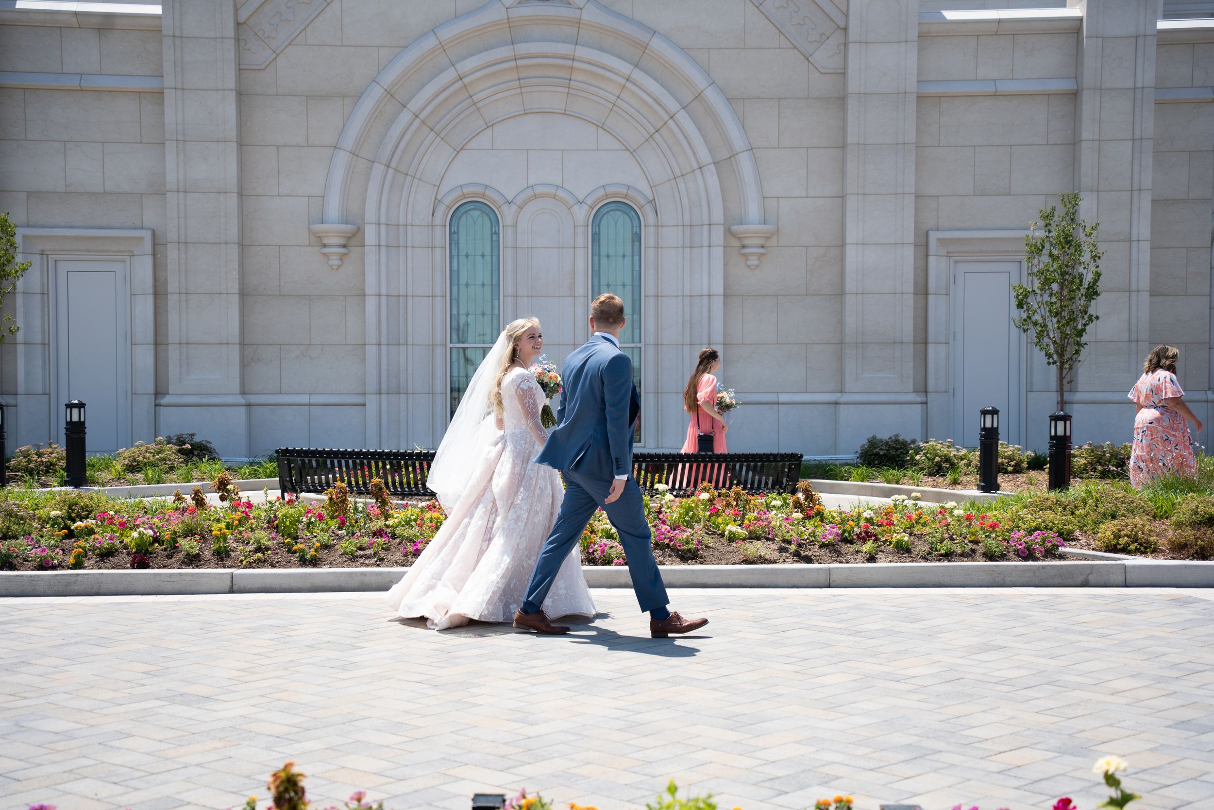 Post temple sealing bride and groom walking with family in Utah