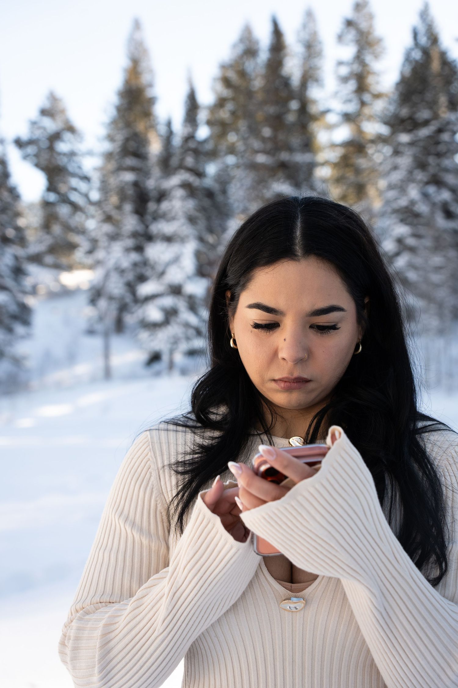 Bride signing her marriage certificate outdoors in a snowy Big Cottonwood Canyon forest after her elopement