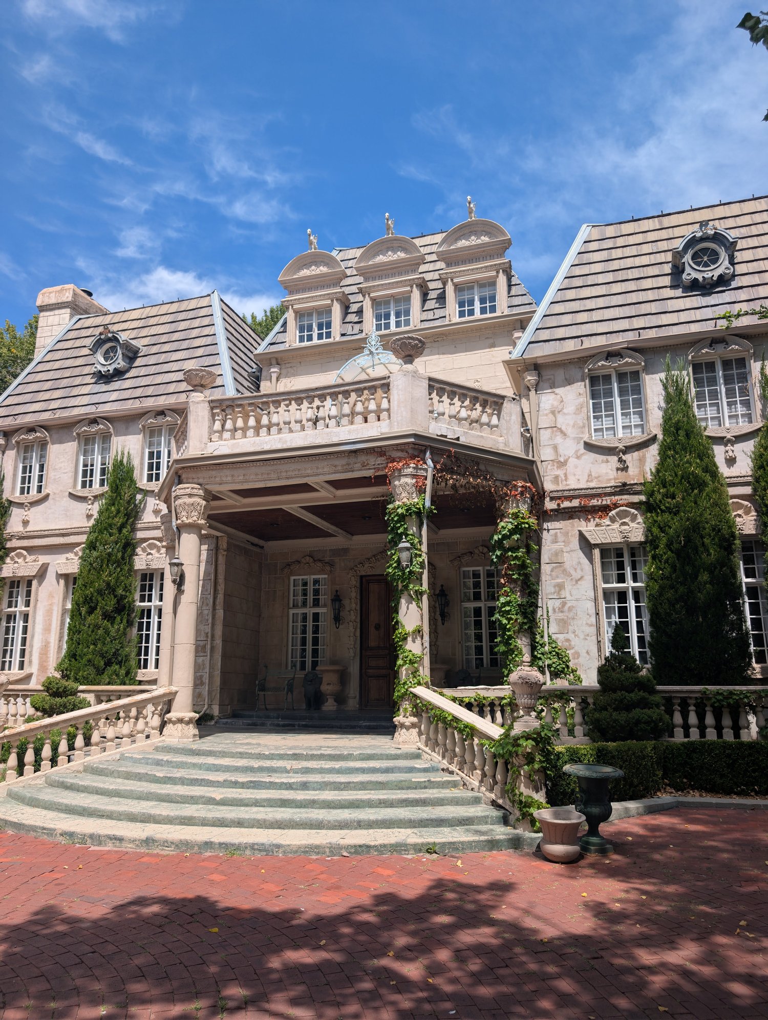 La Caille's Chateau viewed from the front, a stone French manor with dormer windows and a covered entry