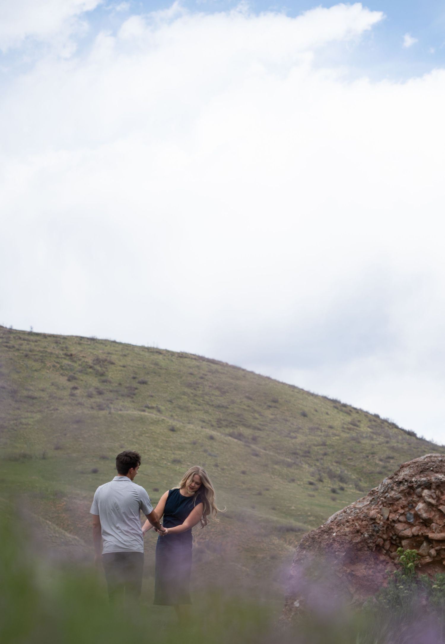 newly engaged couple dancing in a field of wildflowers in springville canyon. thoughtful proposal photo