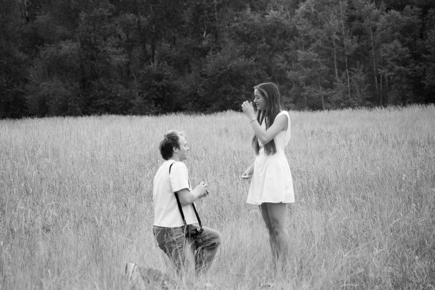 boyfriend proposing to girlfriend in field at big spring park up provo canyon. romantic proposal