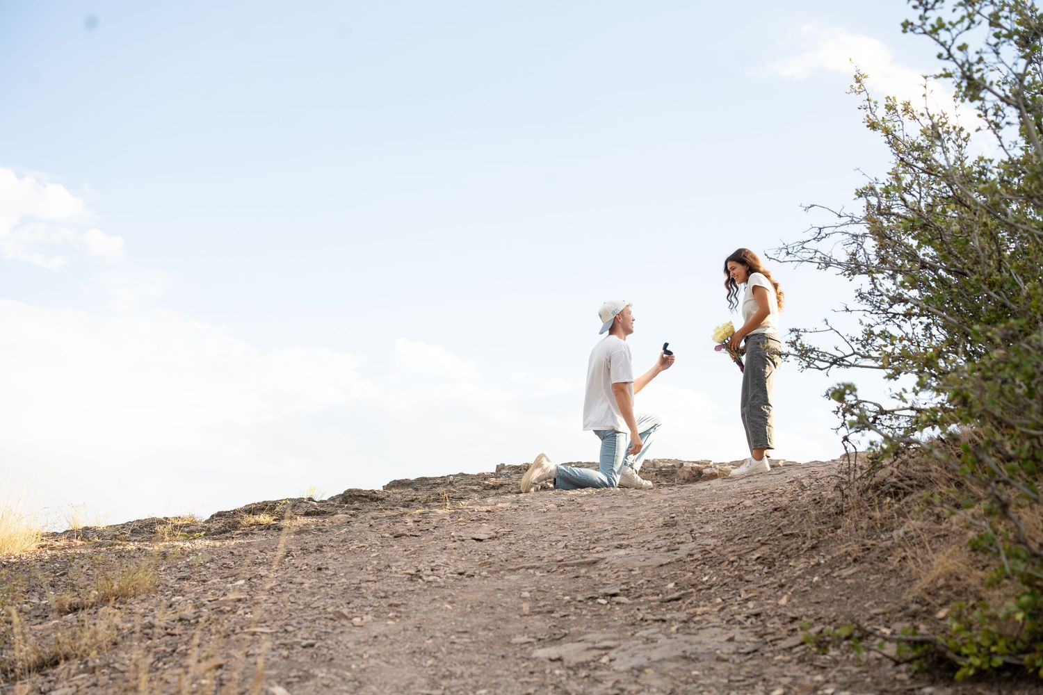 Couple getting engaged after hiking, romantic surprise proposal