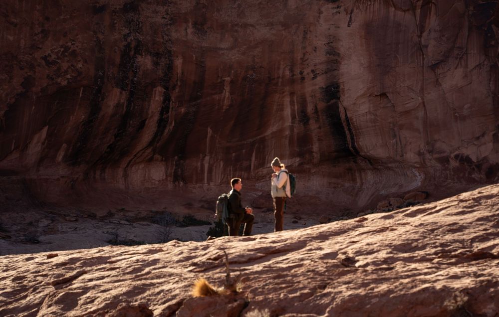 Man proposing to his girlfriend beneath Corona Arch in Moab, Utah