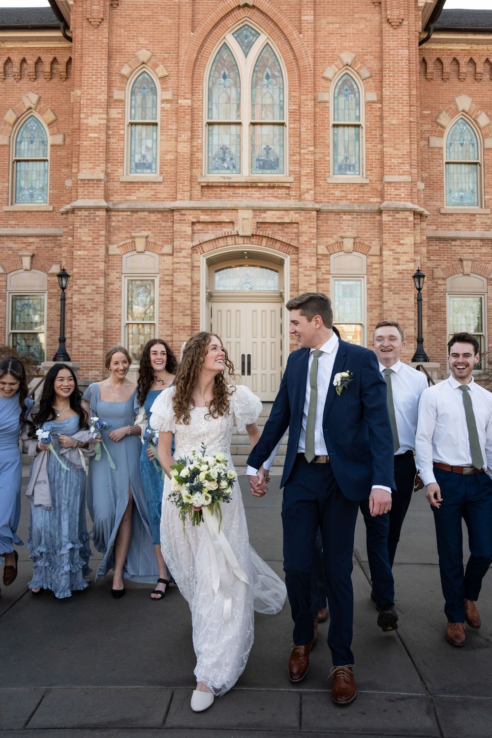 Bride and groom walk hand-in-hand before Provo City Center Temple