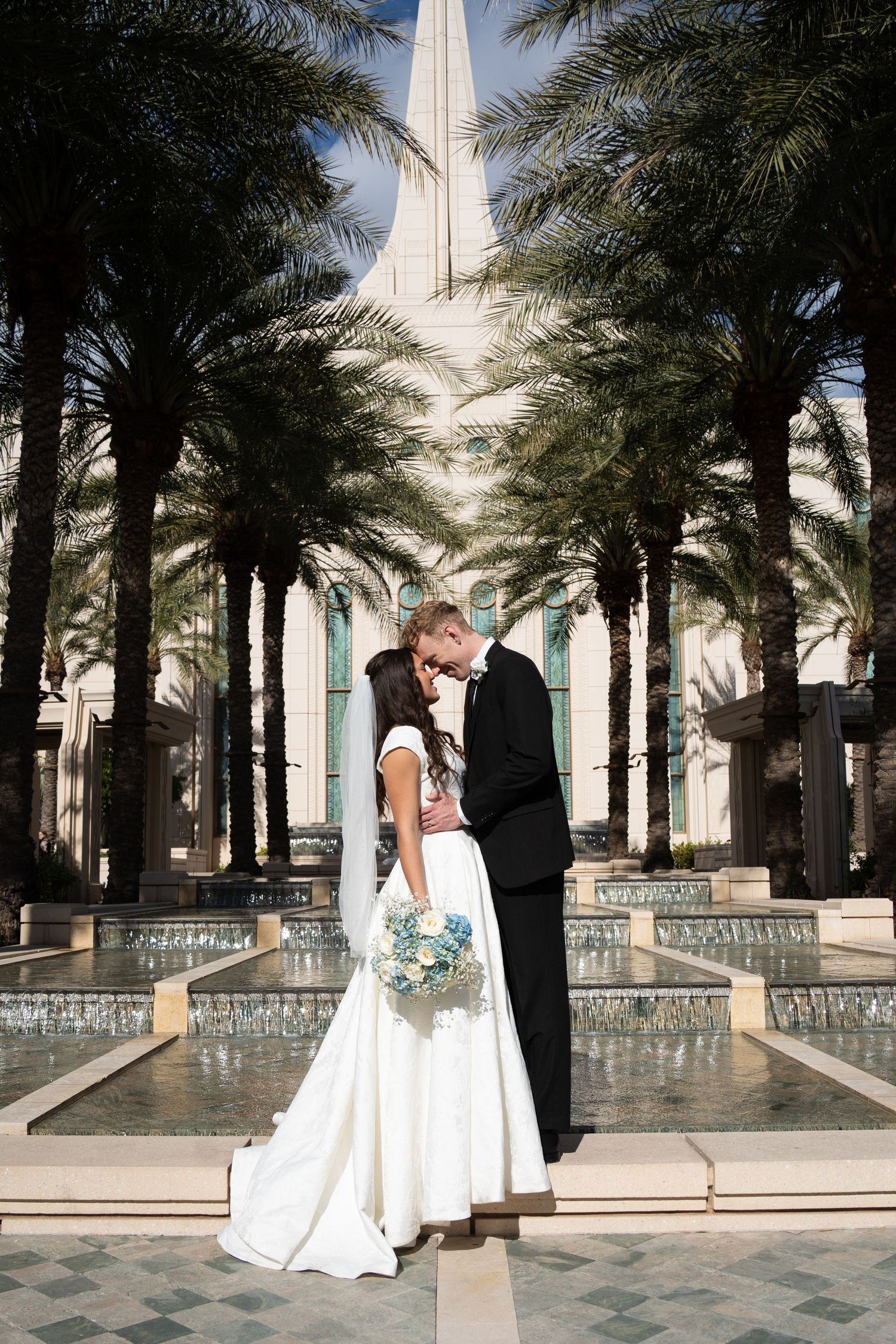 bride and groom stare into each others eyes in front of mount timpanogos lds temple in Lehi Utah following their temple sealing ceremony