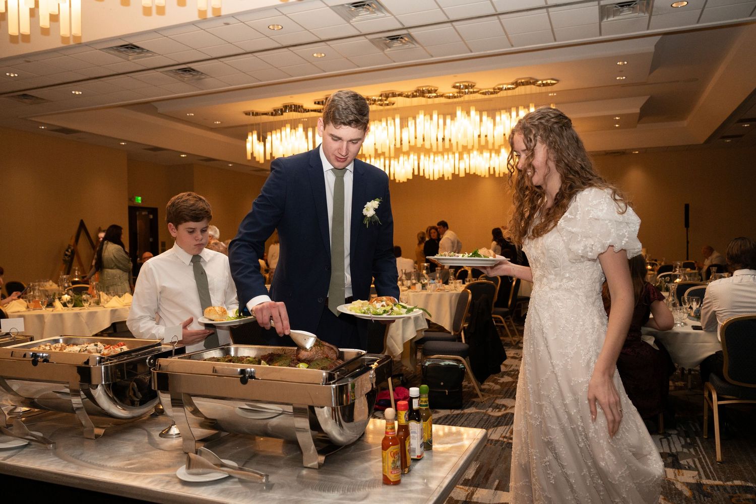 bride and groom eating during wedding dinner party reception grand ballroom